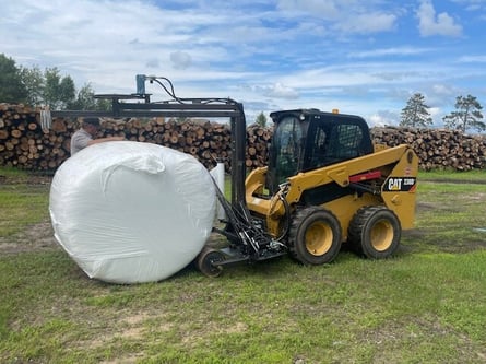 The HWP-Bale Wrapper with a wrapped round hay bale.