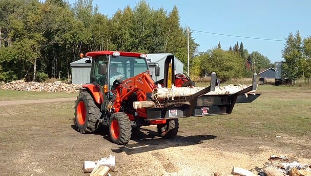 The Halverson Wood Products HWP-120 carrying a log.