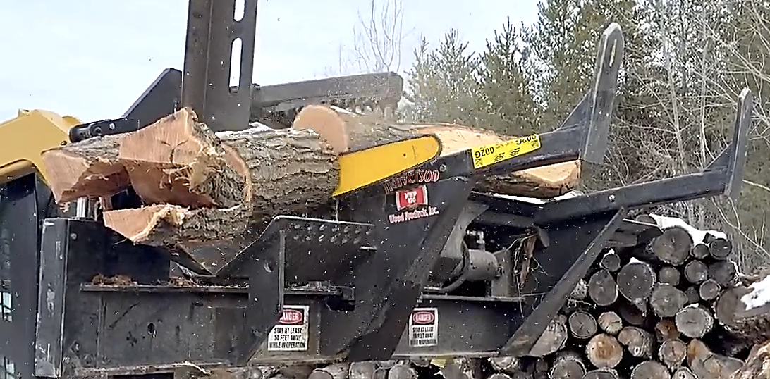 A Halverson HWP-160 firewood processor cutting logs.