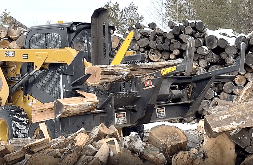 A Halverson HWP-160 firewood processor cutting logs.