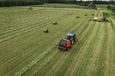 A farmer mows hay